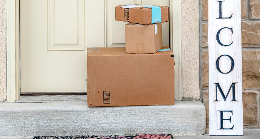 Boxes by the door of a residence with a welcome sign in Brownsville